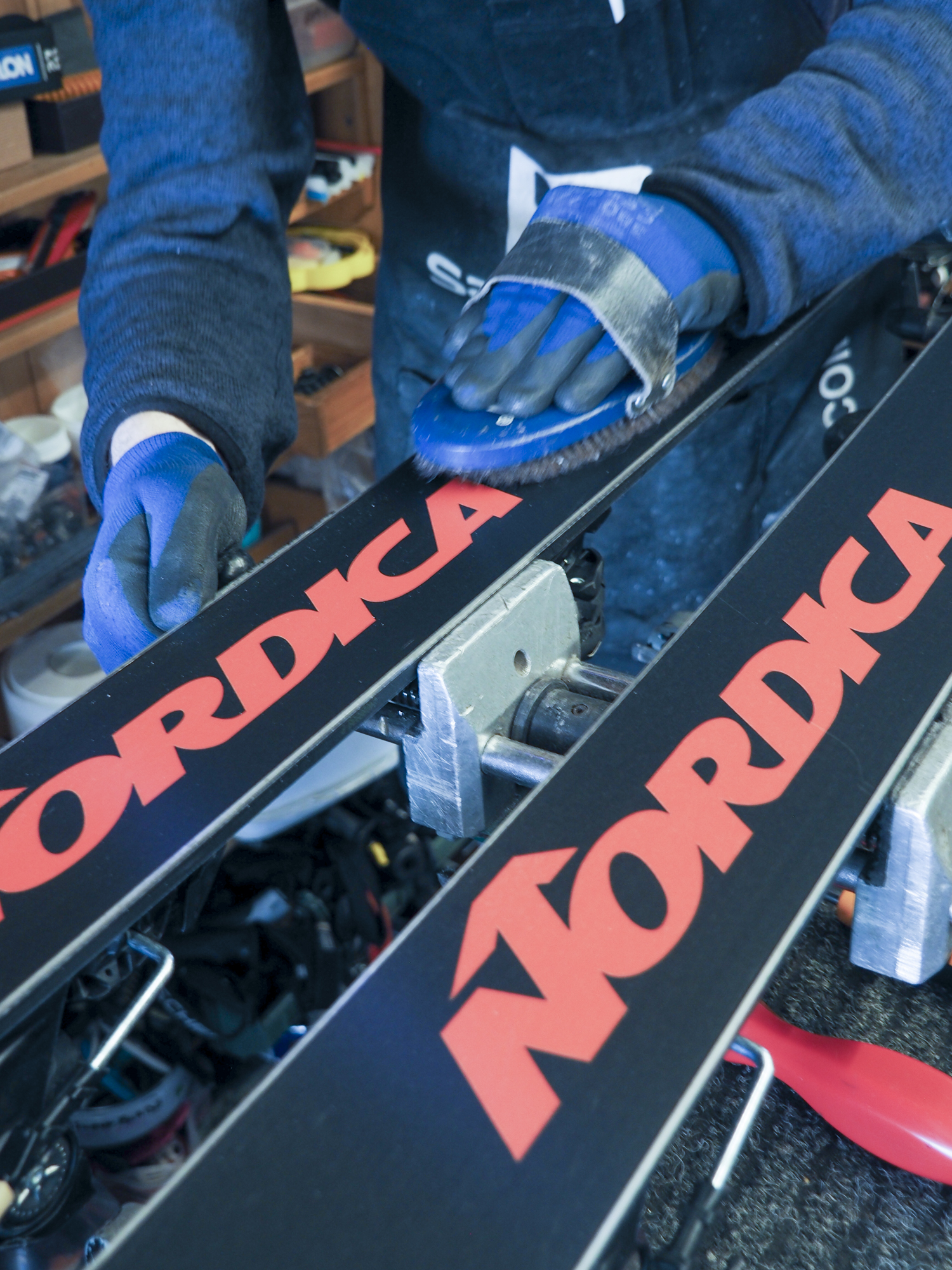 Technicien brossant la semelle de skis